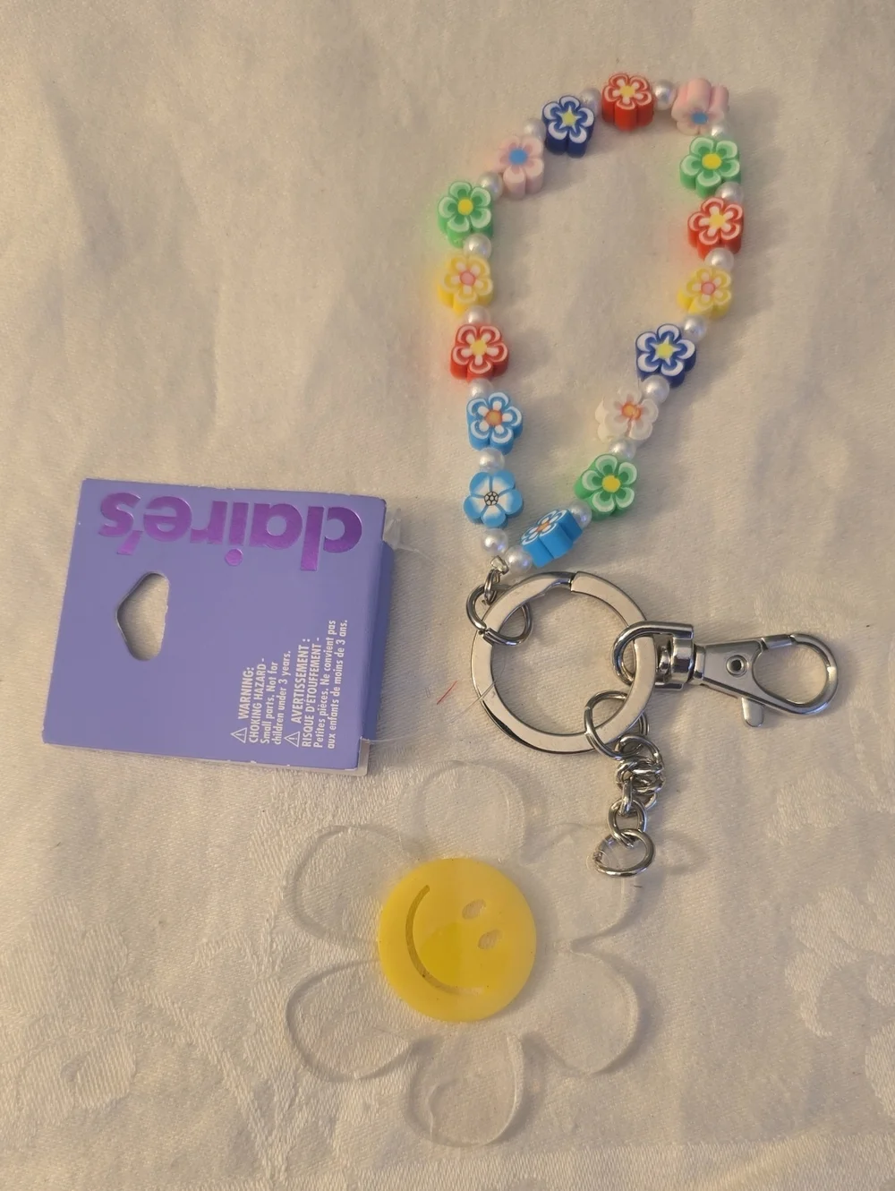 Claire's Multicolor Flower Bead Charm Keychain with Yellow Smile Accent